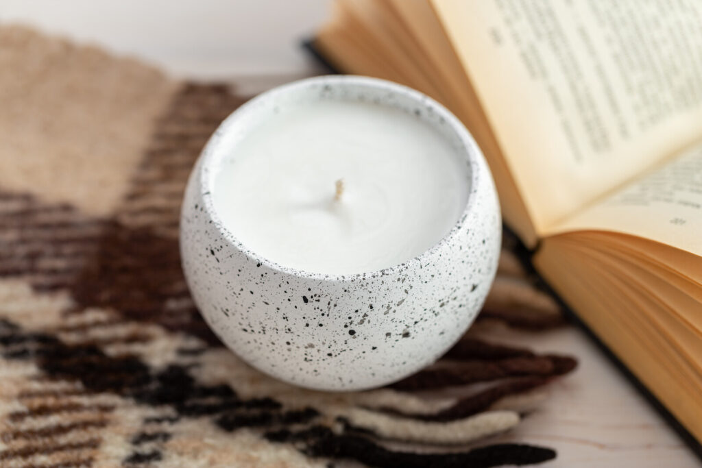 closeup image of a rounded container of organic candle