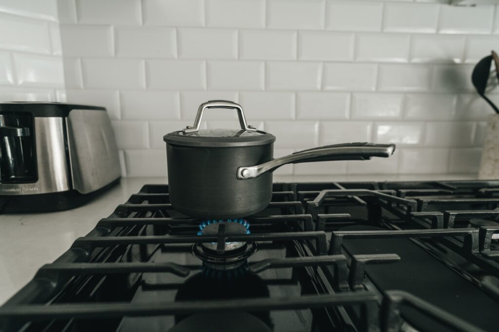 freshly cleaned stove top with a pot on