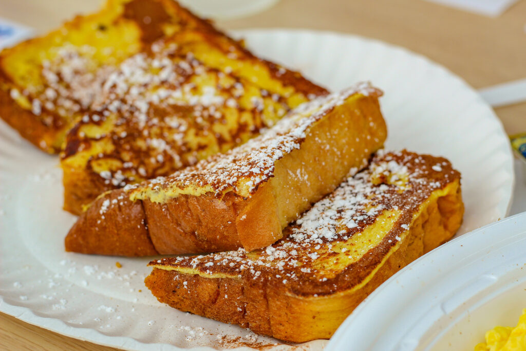 a plate of French toast with a good sprinkling of white sugar, representing the article "Easy To Cook Breakfast To Start Your Day" by My Kitchendom