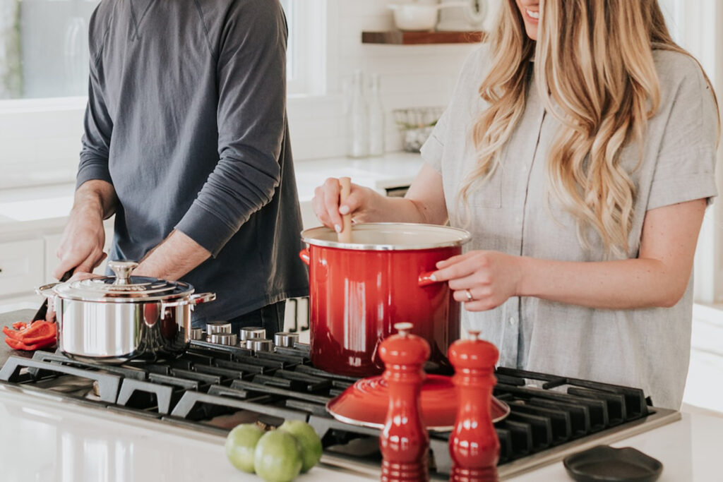 couple cooking dinner representing the article Christmas Dinner Tips by My Kitchendom