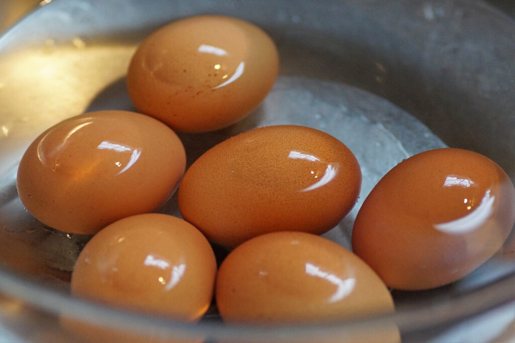 a bowl of water with brown hard boiled eggs, representing the article "10 Easy To Cook Breakfast To Start Your Day" by My Kitchendom