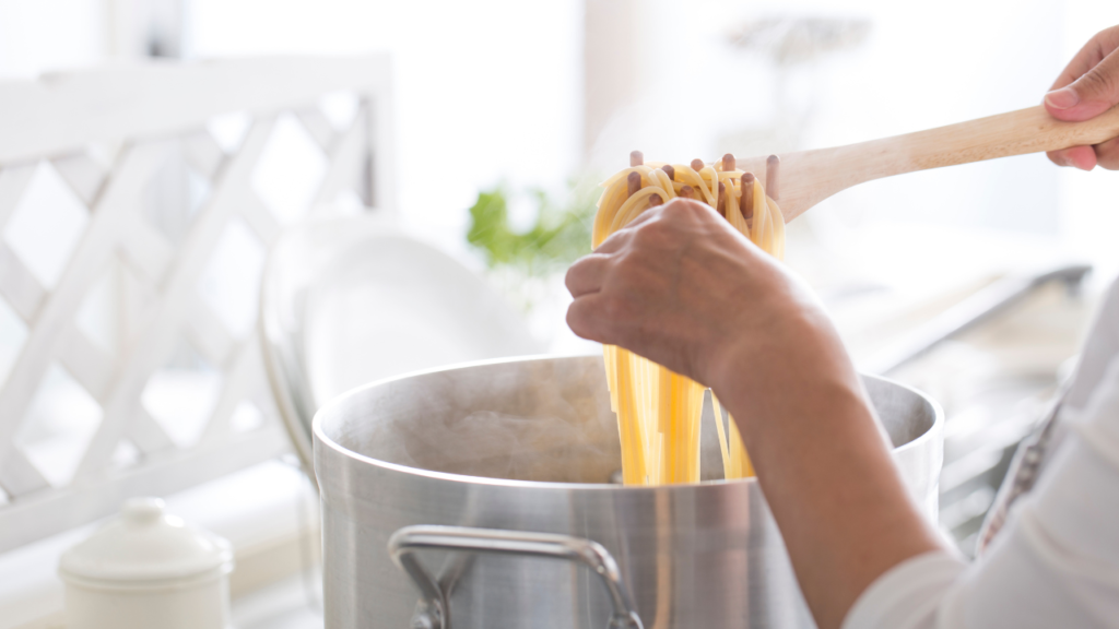 checking pasta's doneness, representing the article "But First, How to Cook Pasta" by My Kitchendom