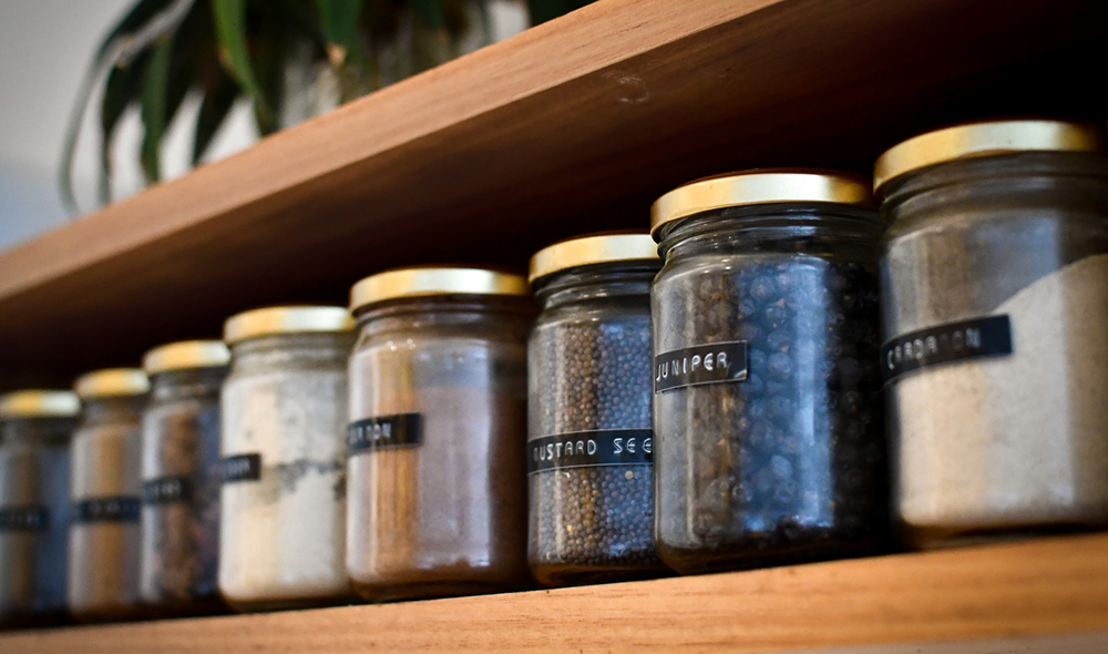 closeup image of floating shelves representing the article "No Pantry, No Problem: How To Organize a Small Kitchen Without a Pantry" by My Kitchendom