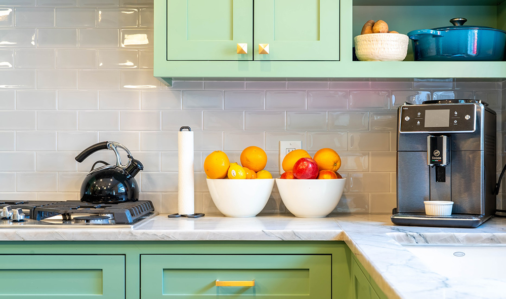 kitchen counter with a couple of big white bowls of fruits